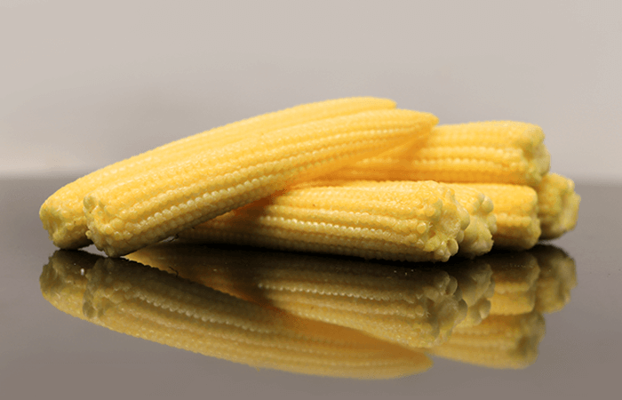Fresh peeled baby corn packed in punnets